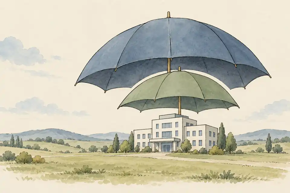 Illustration of two overlapping umbrellas with a small gap between them over a simple hospital building.