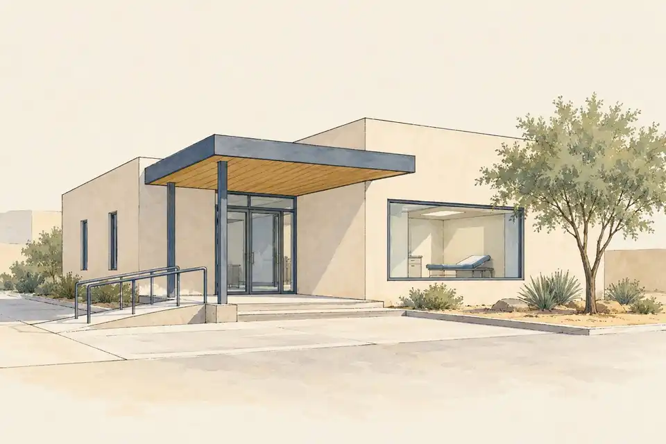 Illustration of a plain clinic with a shaded entrance, access ramp and examination couch visible through a window.